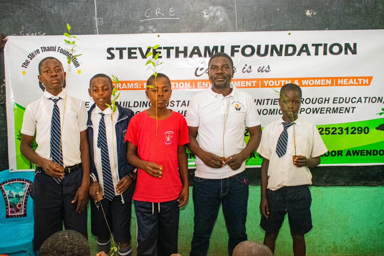 Kenyan youth posing with Steve Thami Foundation banner
